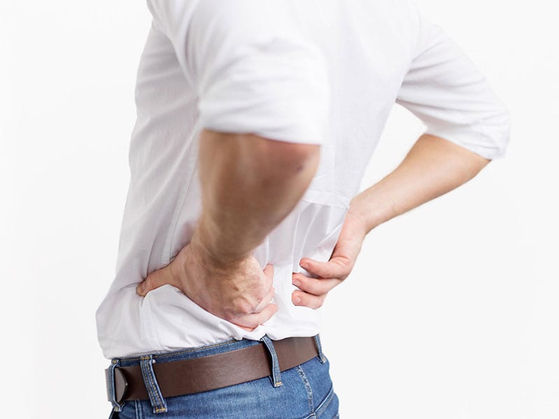main experiencing back pain from sports injuries