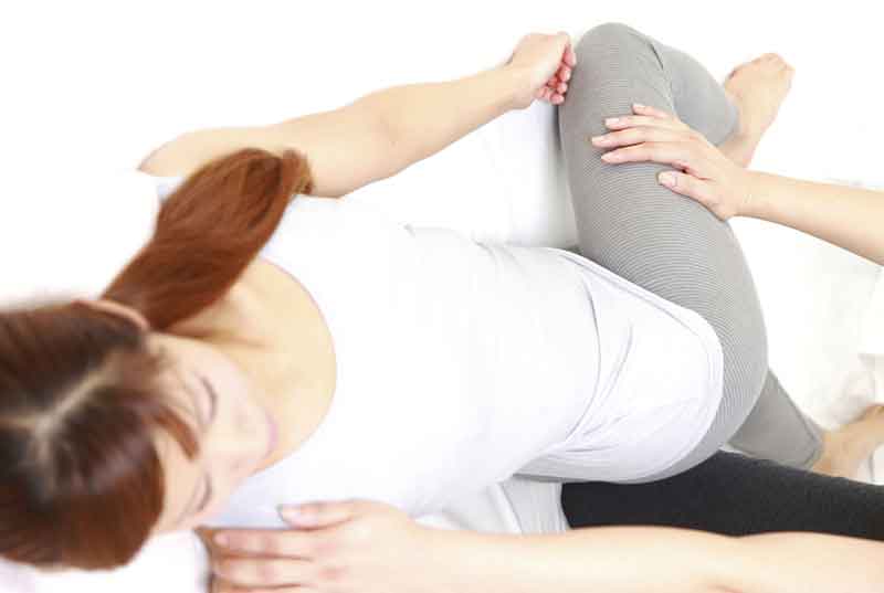 Women having adjustment done by chiropractor